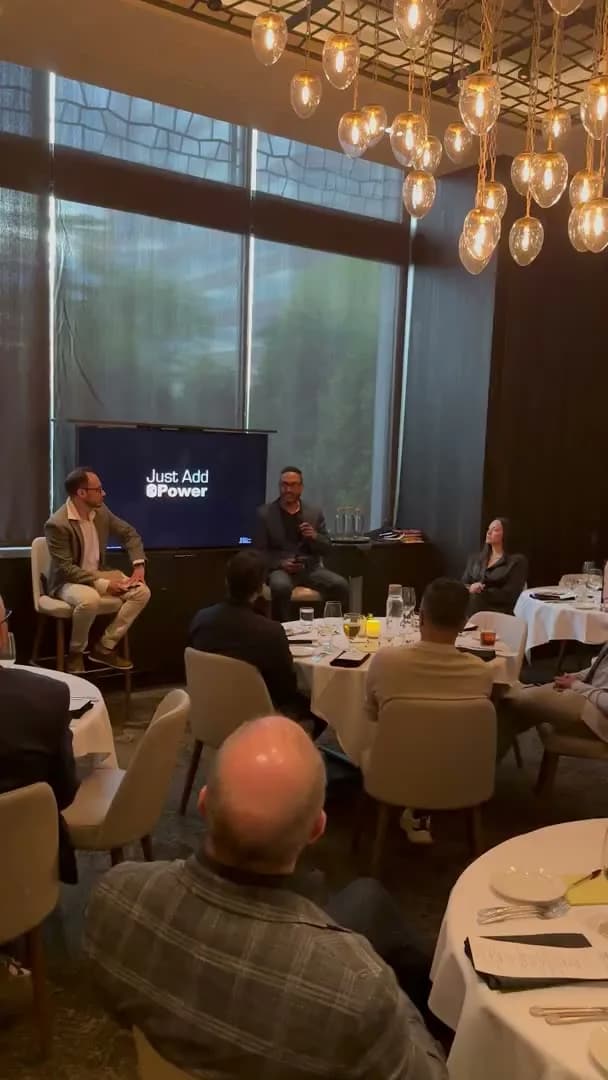 The talk under way, guests turned toward the front of the room