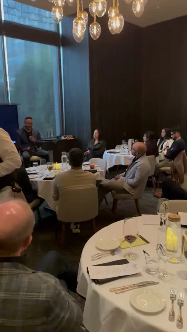 A wide view down the room while the speaker holds the floor