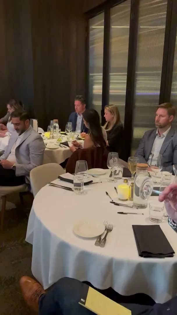 Guests settling at the tables at the back of the room