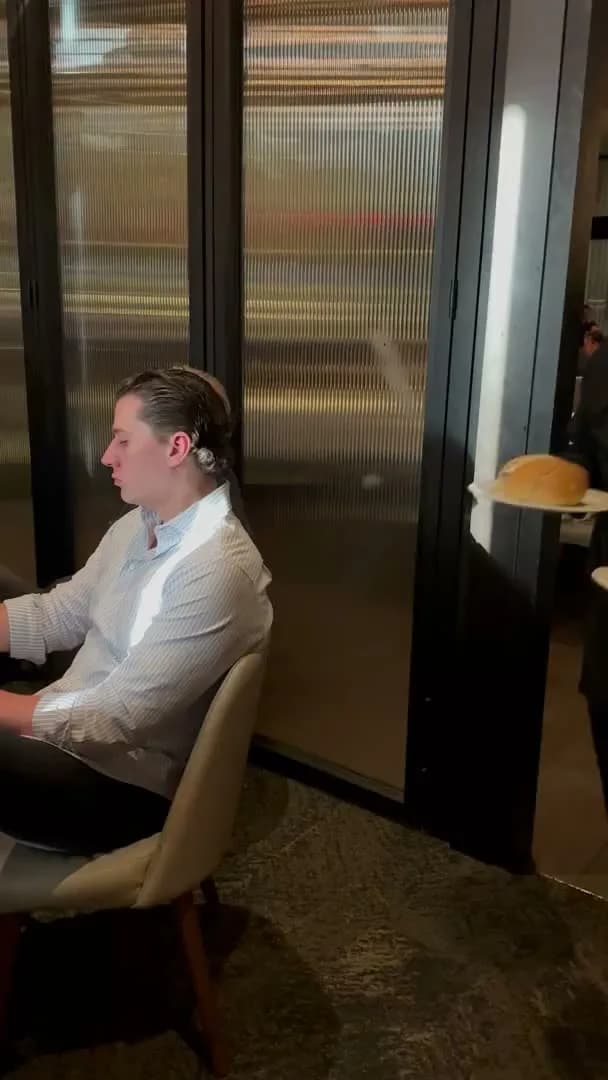 A server passing with bread while the talk goes on