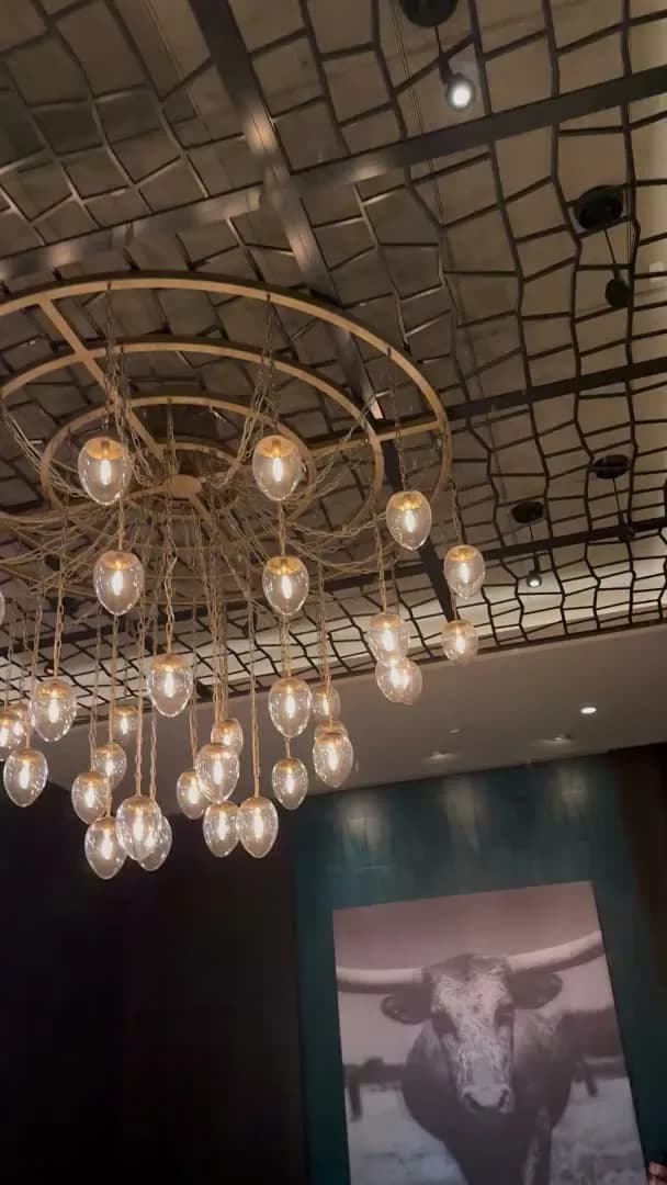 A detail of the beaded chandelier and the lattice ceiling above the room
