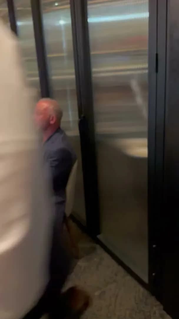 A guest stepping out past the glass partition