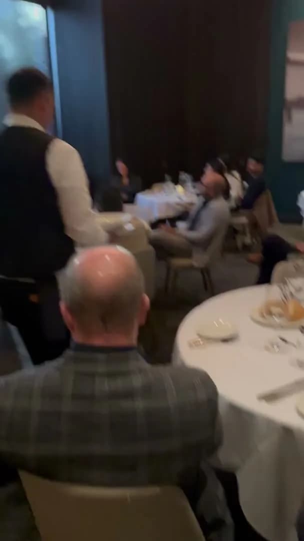 A server working the room between courses